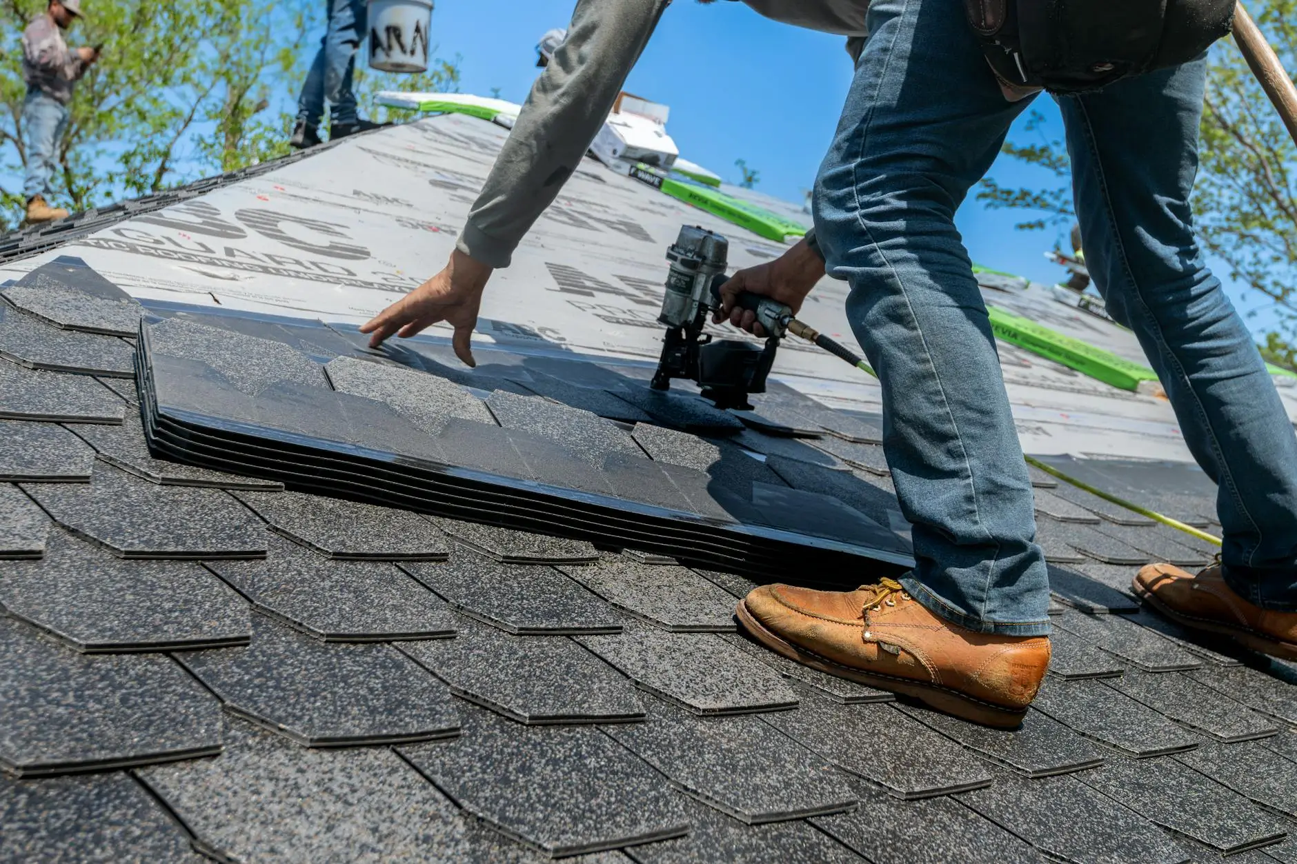 Professional roofers installing dimensional shingles on a multi-family commercial building in Centerville